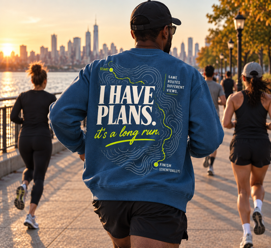 Race Scoop I Have Plans blue crewneck worn by a runner during a long run, featuring bold route inspired back artwork in a waterfront running setting.