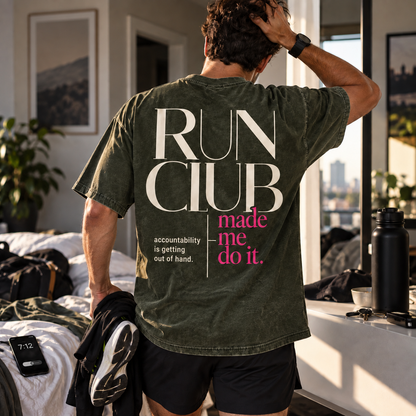 Race Scoop Run Club Made Me Do It olive graphic tee worn while getting ready for a morning run, featuring statement back artwork inspired by run club accountability.