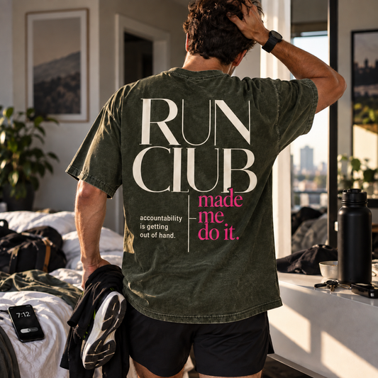 Race Scoop Run Club Made Me Do It olive graphic tee worn while getting ready for a morning run, featuring statement back artwork inspired by run club accountability.