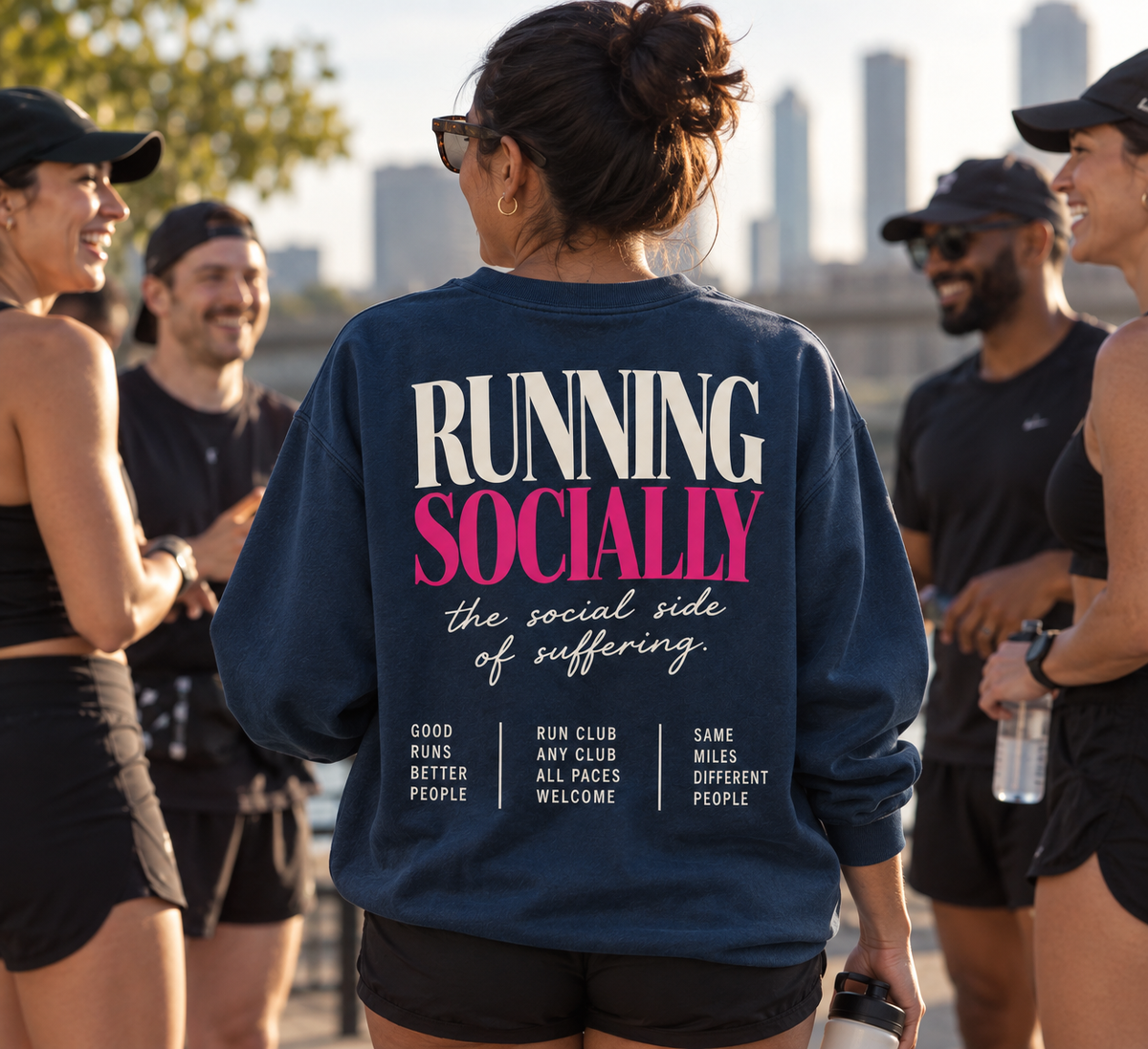 Race Scoop Running Socially blue crewneck worn at a social run club meetup, featuring community inspired back artwork celebrating runners, connection and all paces.